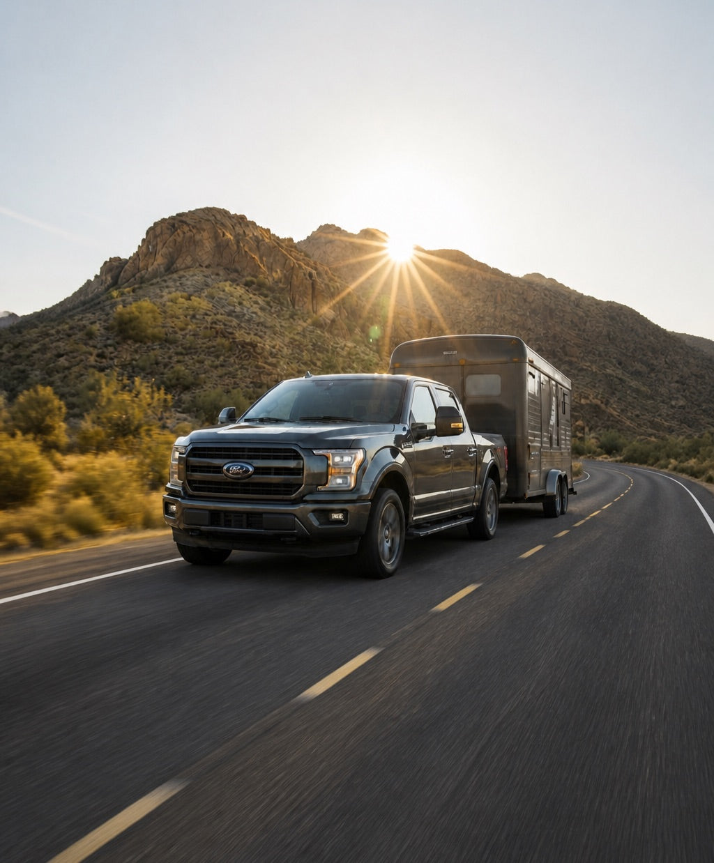 Pickup truck towing a trailer on a desert highway
